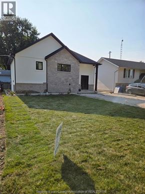 Colchester apartment for rent - A house with a white and brown exterior is surrounded by a green lawn.