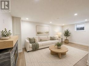 Welland (Prince Charles) apartment for rent - A living room with a couch, coffee table, and plants.