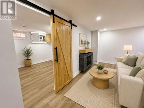 Welland (Prince Charles) apartment for rent - A wooden door in a room with a couch and a table.