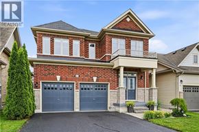 Niagara-On-The-Lake apartment for rent - A two-story house with a brick facade and a grey garage door.