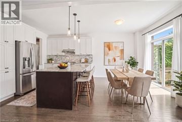 Niagara-On-The-Lake apartment for rent - A modern kitchen with a dining table and chairs.