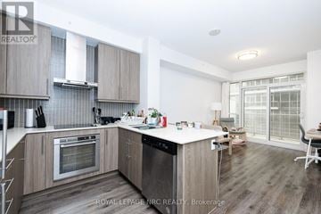 Burlington (Freeman) condo for rent - A modern kitchen with wooden cabinets and a white island.