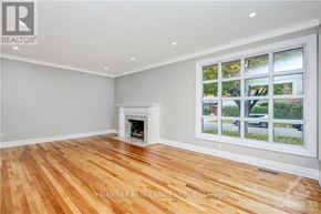 Ottawa apartment for rent - A room with a fireplace and a window showing a street view.