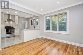 Ottawa apartment for rent - A spacious kitchen with wood flooring and a large window.