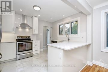 Ottawa apartment for rent - A modern kitchen with white cabinets and a stainless steel oven.
