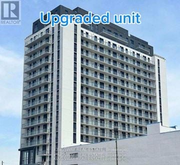 Brantford condo for rent - A tall building with the words "Upgraded unit" written across the top.