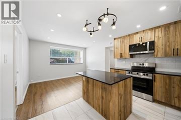 Scarborough apartment for rent - A modern kitchen with wooden cabinets and a black countertop.