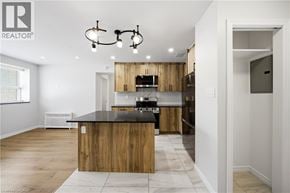 Scarborough apartment for rent - A modern kitchen with wooden cabinets and a black countertop.