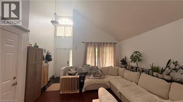 Hamilton apartment for rent - A living room with a white couch and a wooden cabinet.