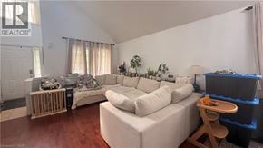 Hamilton apartment for rent - A living room with a white couch and a wooden stool.