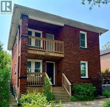 Windsor apartment for rent - A red brick house with a balcony and a door.