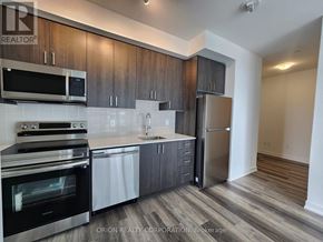 Pickering (Bay Ridges) condo for rent - A kitchen with a stainless steel refrigerator, oven, and microwave.