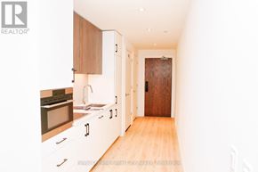 Kitchener condo for rent - A kitchen with wooden cabinets and a sink.