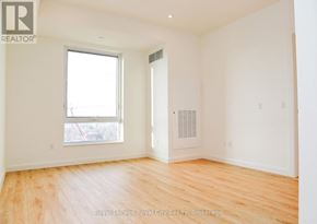 Kitchener condo for rent - A room with wooden floors and a window.