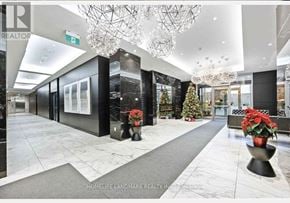Toronto (Clanton Park) condo for rent - A hallway with a Christmas tree and a chandelier.