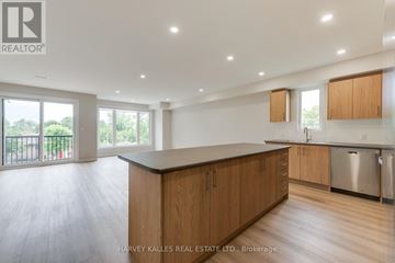 Toronto (Downsview-Roding-Cfb) multi-family for rent - A spacious kitchen with wooden cabinets and a large island.