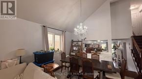 Hamilton apartment for rent - A well-lit dining area with a chandelier and a table set for six.