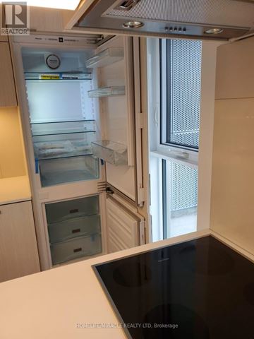 Toronto (Waterfront Communities) condo for rent - A kitchen with a refrigerator and a microwave.