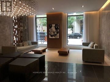Toronto (Church-Yonge Corridor) condo for rent - A modern living room with a large chandelier and a large painting on the wall.