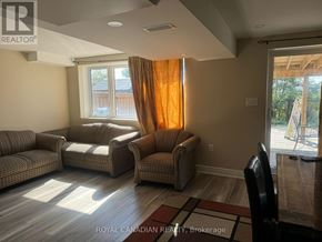 Cambridge apartment for rent - A living room with a couch, chairs, and a window with curtains.