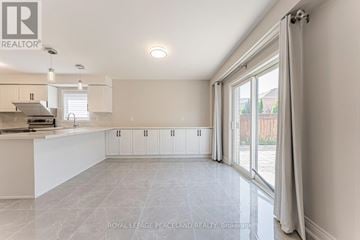 Newmarket (Woodland Hill) apartment for rent - A spacious kitchen with white cabinets and a marble floor.