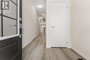 Cambridge townhouse for rent - A hallway with a white door and a black door on the left.