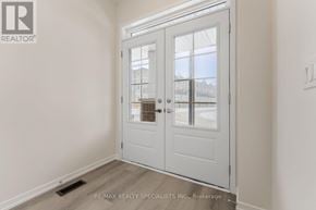Cambridge townhouse for rent - A white door with a glass window is in a room with white walls.