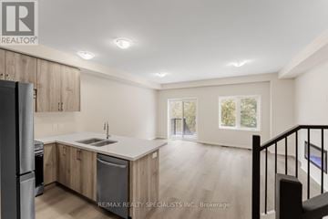 Cambridge townhouse for rent - A kitchen with wooden cabinets and a stainless steel refrigerator.