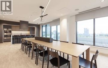 Burnaby apartment for rent - A modern dining room with a long table and chairs.