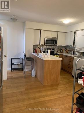 Toronto (Bay Street Corridor) house for rent - A kitchen with a wooden island and white appliances.