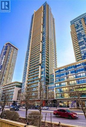 Mississauga (Creditview) condo for rent - A tall building with a glass facade stands in front of two other buildings.