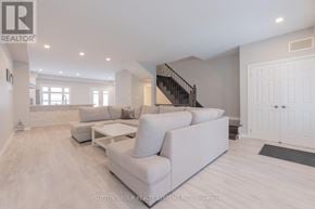 Oakville (Jc Joshua Creek) townhouse for rent - A spacious living room with a staircase and a couch.