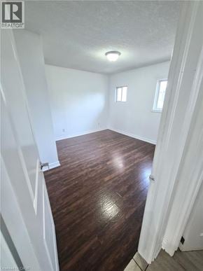 Hamilton apartment for rent - A room with wooden flooring and white walls.