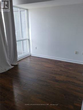 Toronto (Waterfront Communities) condo for rent - A room with wooden flooring and a window.