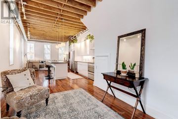 Hamilton (Beasley) apartment for rent - A living room with a chair and a table.