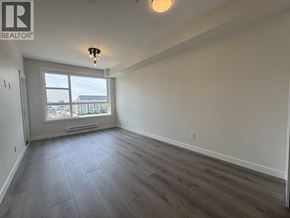 Maple Ridge apartment for rent - A spacious room with a large window and wooden flooring.
