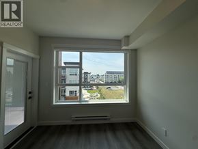 Maple Ridge apartment for rent - A room with a large window overlooking a cityscape.