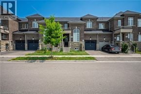 Milton townhouse for rent - A large, multi-story residential building with a tree in front and a car parked in the driveway.