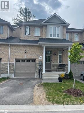 Wasaga Beach townhouse for rent - A house with a grey garage door is for sale.