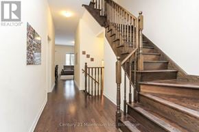 Wasaga Beach townhouse for rent - A wooden staircase with a metal railing.