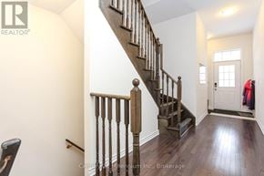 Wasaga Beach townhouse for rent - A wooden staircase with a metal railing.