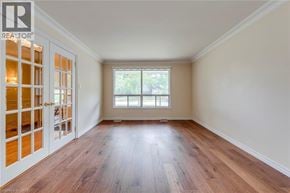 Oakville apartment for rent - A room with wooden floors and a window letting in light.