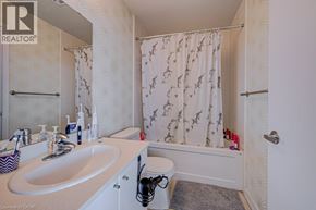 Mississauga condo for rent - A bathroom with a sink, mirror, and shower.