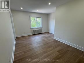 Toronto (Leaside) apartment for rent - A room with wooden flooring and a window with a white frame.