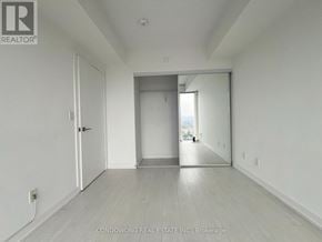Toronto (Waterfront Communities) condo for rent - A spacious room with a door and a window.