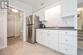 Orangeville apartment for rent - A kitchen with white cabinets and a stainless steel refrigerator.