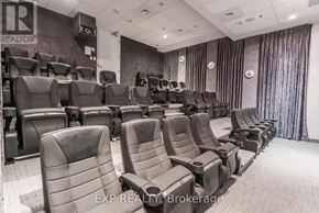 Ottawa condo for rent - A row of black cinema seats are empty and facing a screen.