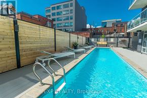 Ottawa condo for rent - A pool surrounded by a wooden fence and a metal railing.