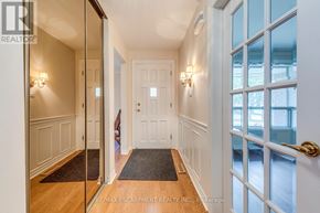 Oakville (Fa Falgarwood) apartment for rent - A hallway with a door at the end and a window on the right.