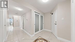 Mississauga (Applewood) condo for rent - A hallway with a rug and a door on the right.